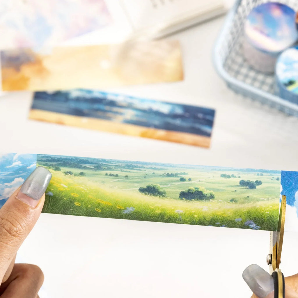 Roll of 30mm wide sky-themed Japanese paper washi tape showing colourful cloud design