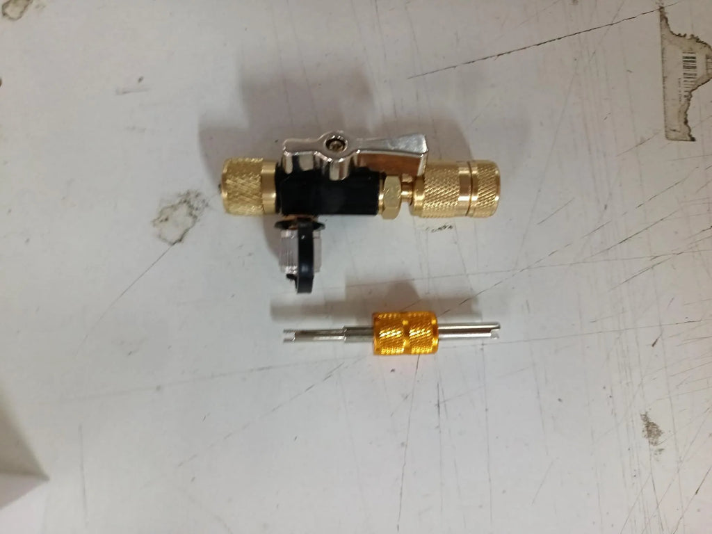 Vacuum valve core disassembly tool set showing black and pink metal valve removers with valve core wrench