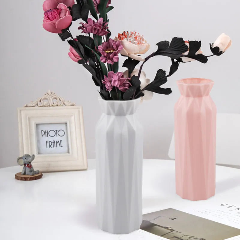 Simple green melamine plastic vase with a wide 7.2 cm base on a wooden table.