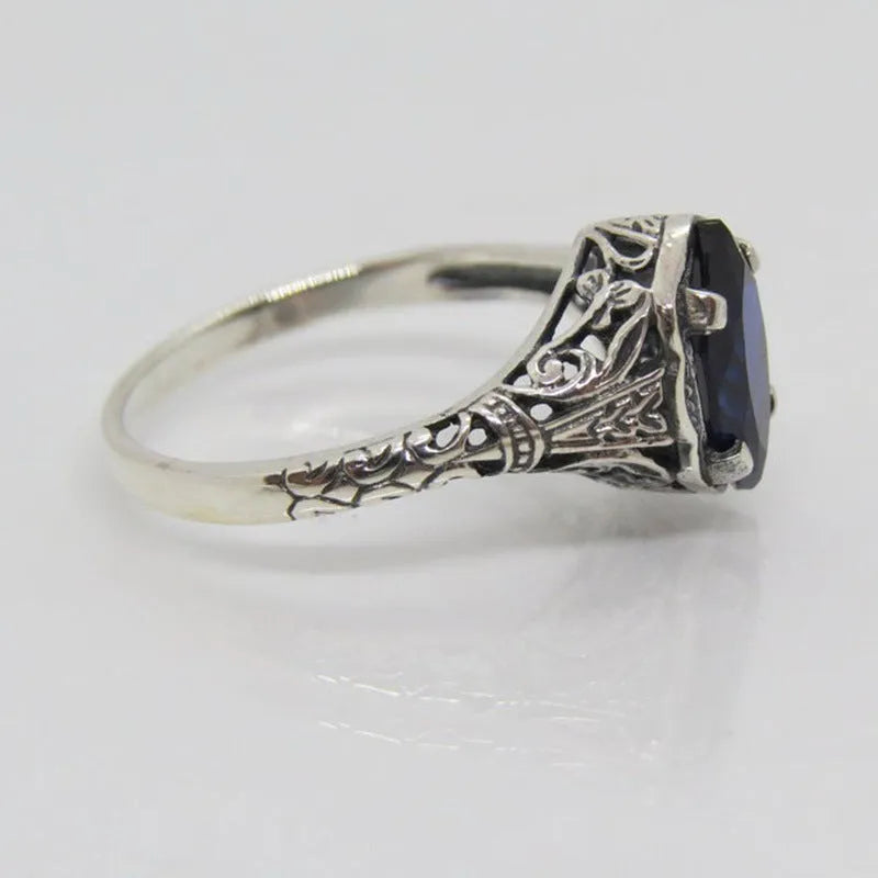 Silver women's geometric hollow ring in electroplated alloy on a plain background.