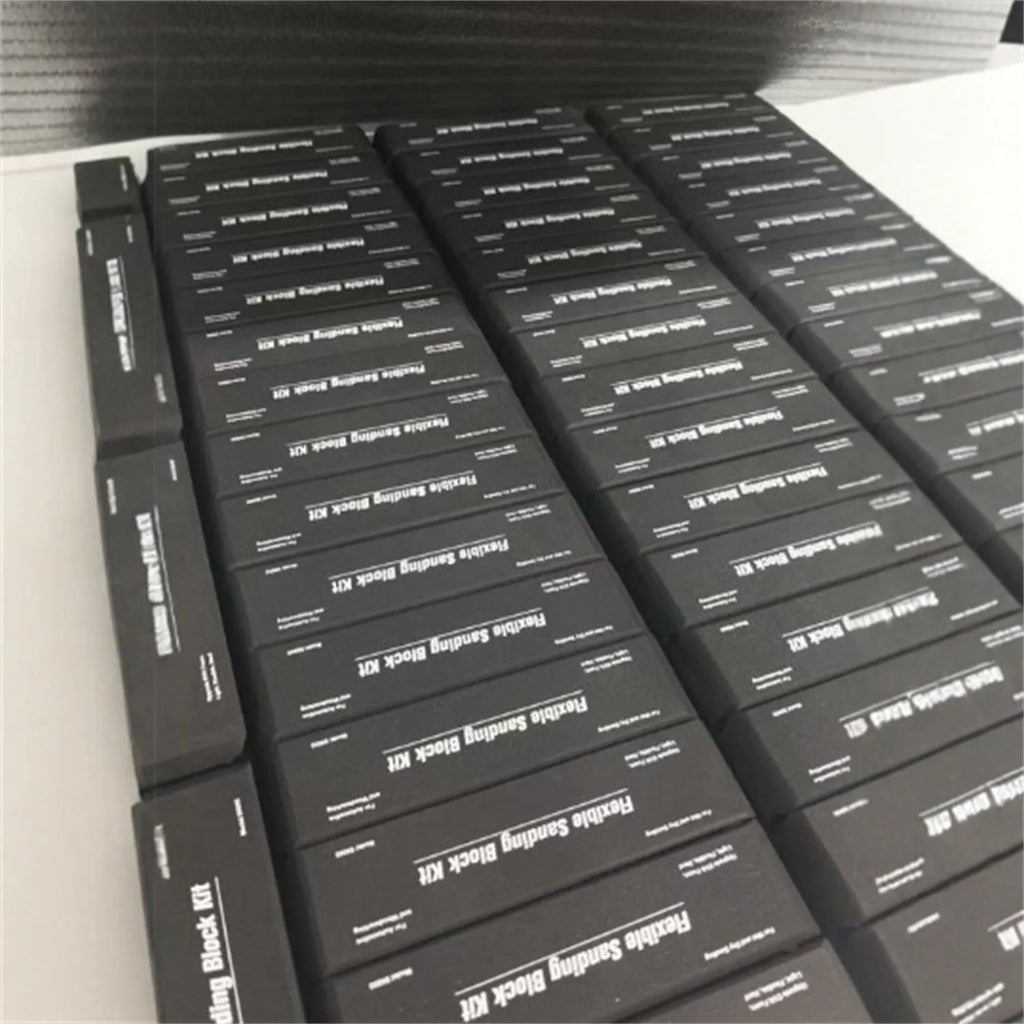 Set of seven black frosted EVA foam blocks inside a metal storage case.