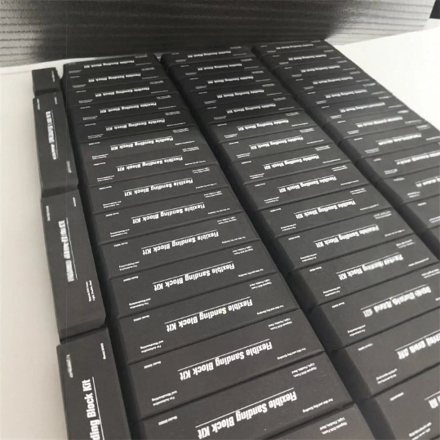 Set of seven black frosted EVA foam blocks inside a metal storage case.