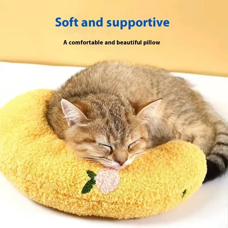 Blue cloth cat sleeping mat in a question mark shape with a U-shaped neck support pillow edge.