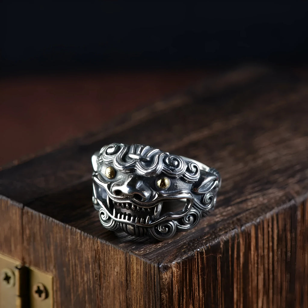 Silver open ring with a detailed domineering Jibeast animal pattern on a model's finger.