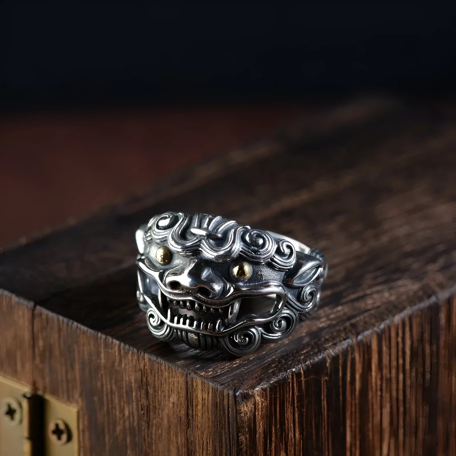 Silver open ring with a detailed domineering Jibeast animal pattern on a model's finger.