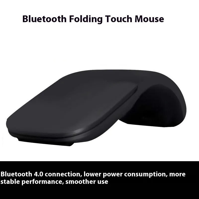 A closed black folding Bluetooth wireless mouse showing its compact size next to a laptop.