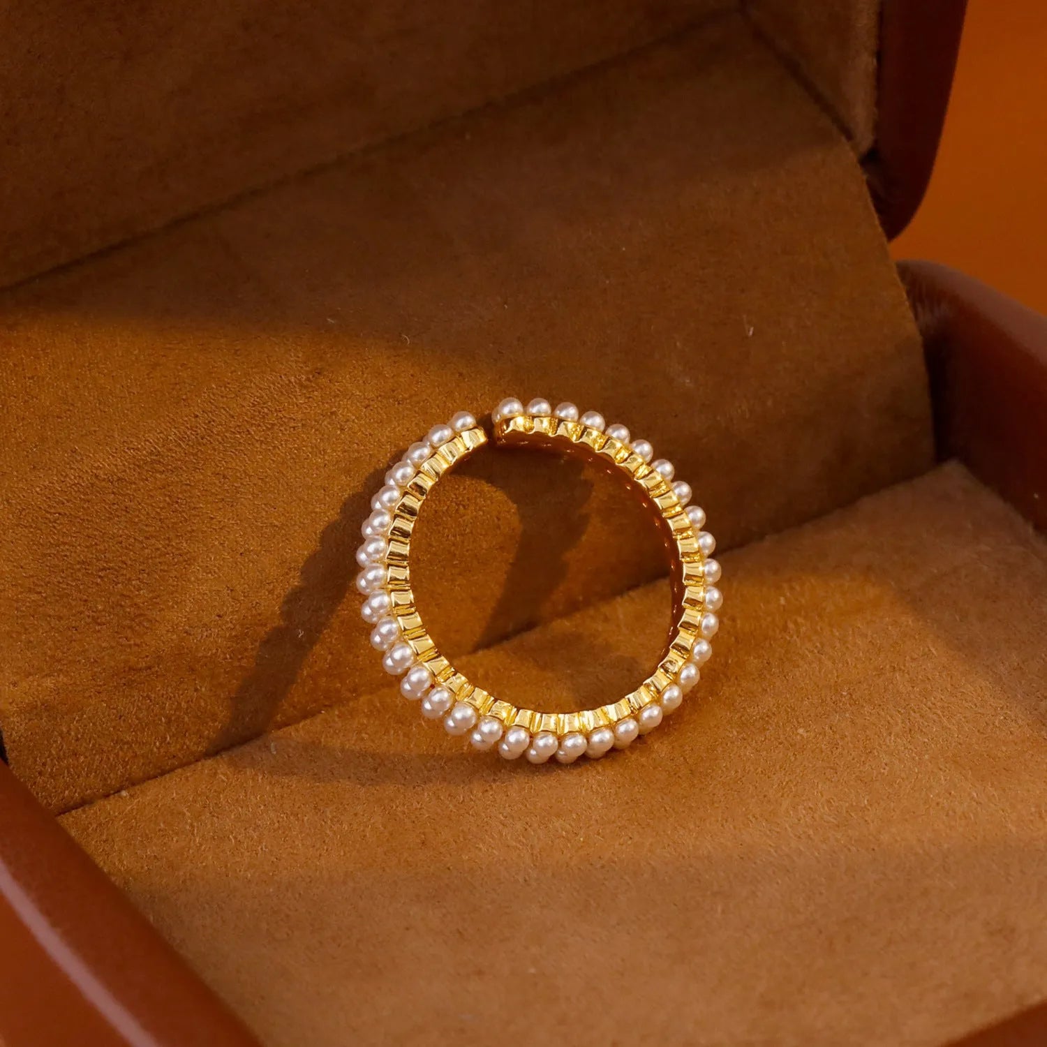 Geometric gold open mouth women's ring with round elements on female hand