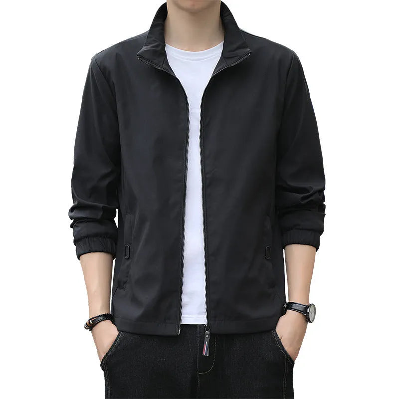 Man wearing a loose-fit black Korean-style autumn jacket with a lapel collar and zipper pockets.