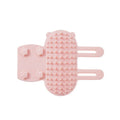 Adjustable silicone cat scratching grooming brush in black, mounted on a table leg.