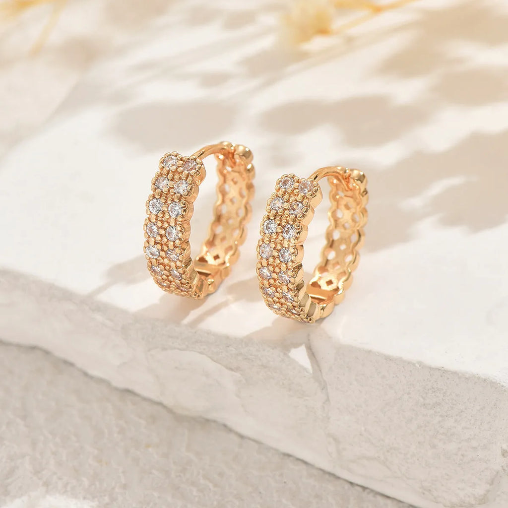 Geometric copper ear studs with circular dot and ring patterns in colour DE20288