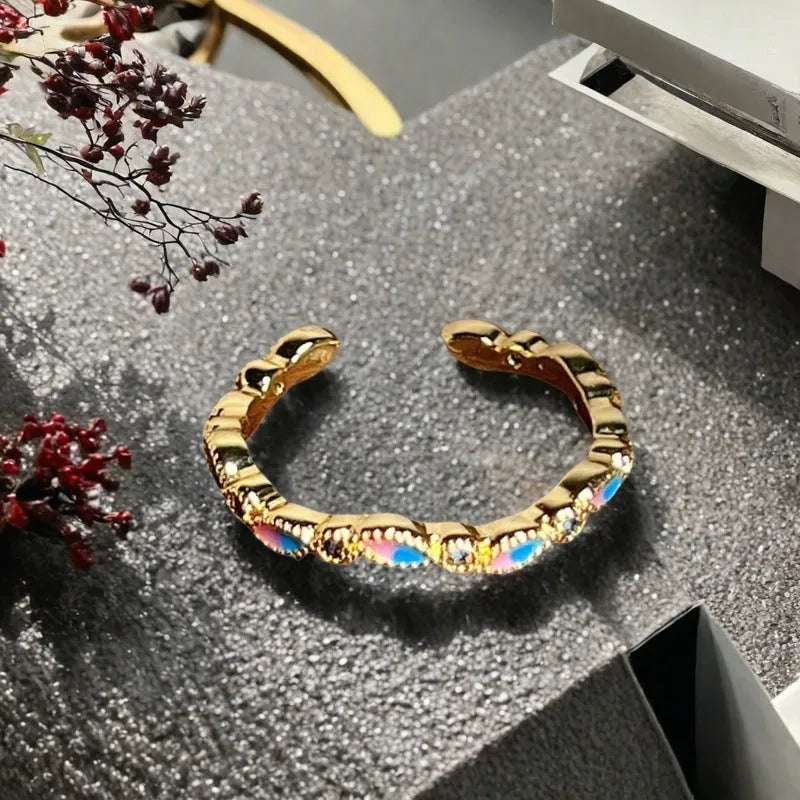 Adjustable copper ring featuring a gourd, flower, and bow design with zircon inlay in New Chinese style.