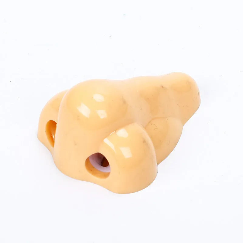 Flesh-coloured plastic pencil sharpener with dual holes for different pencil sizes