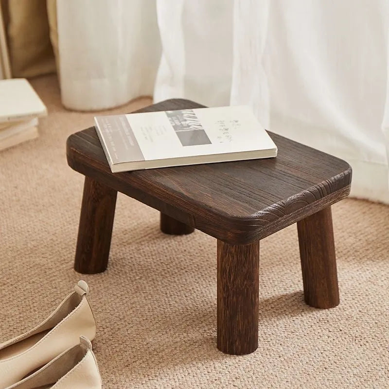 Solid wood household changing stool with a distressed wooden finish.