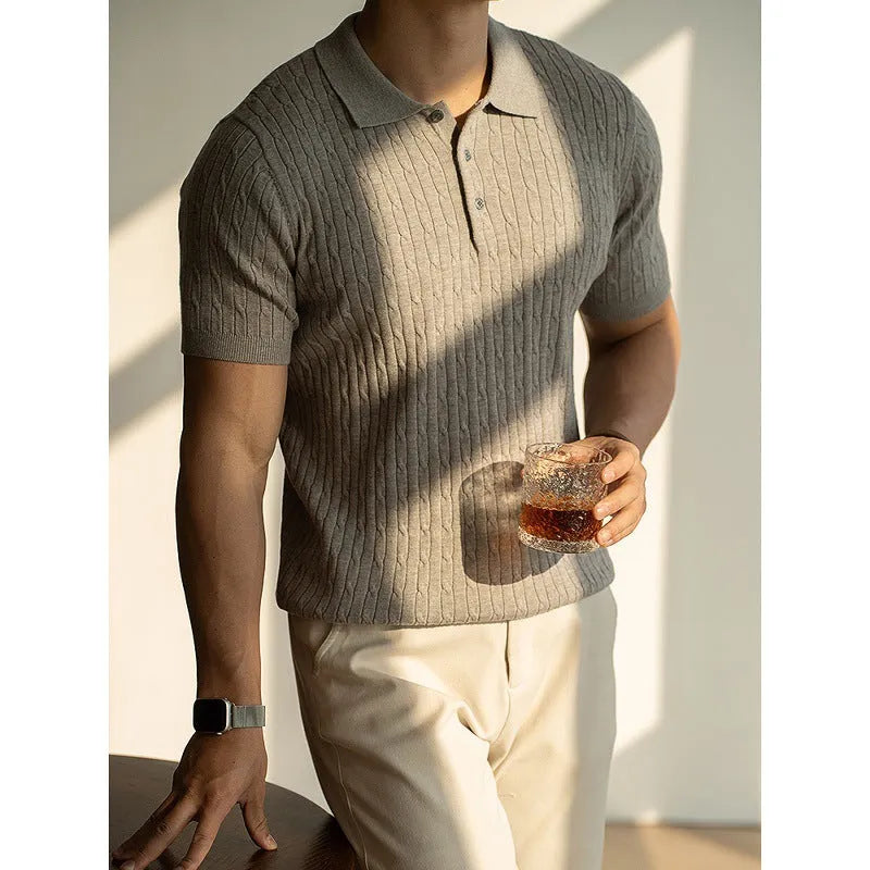 Men's khaki short sleeve business casual top on a hanger.