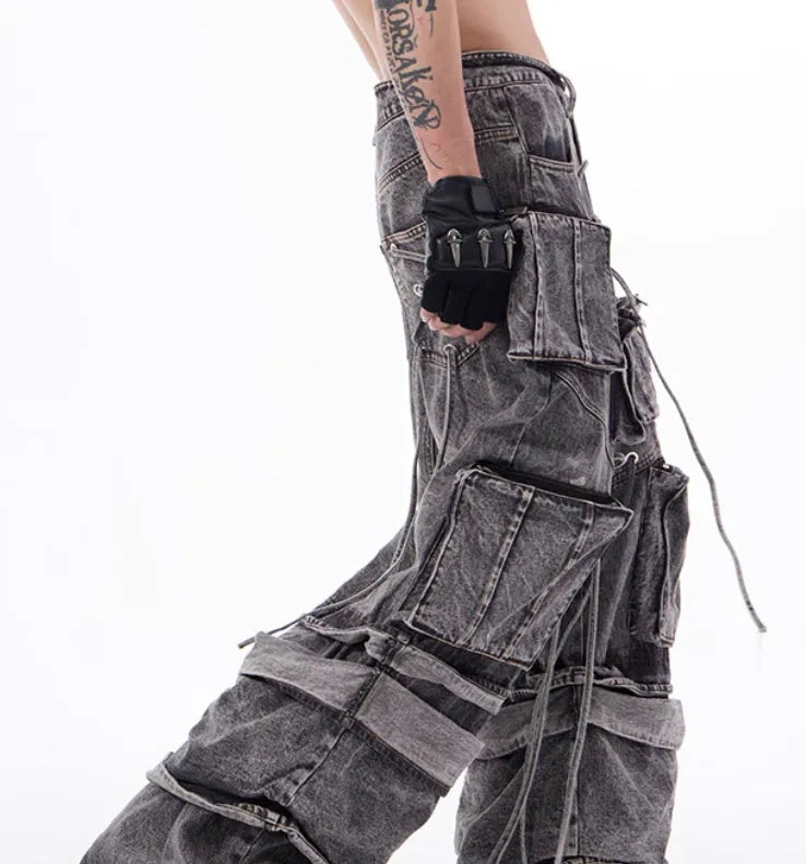 Grey distressed denim overalls with rope stitching on the legs, shown in a casual fit.