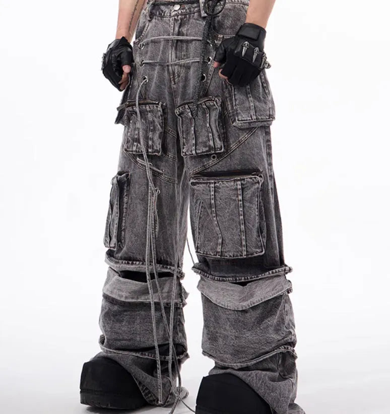 Grey distressed denim overalls with rope stitching on the legs, shown in a casual fit.