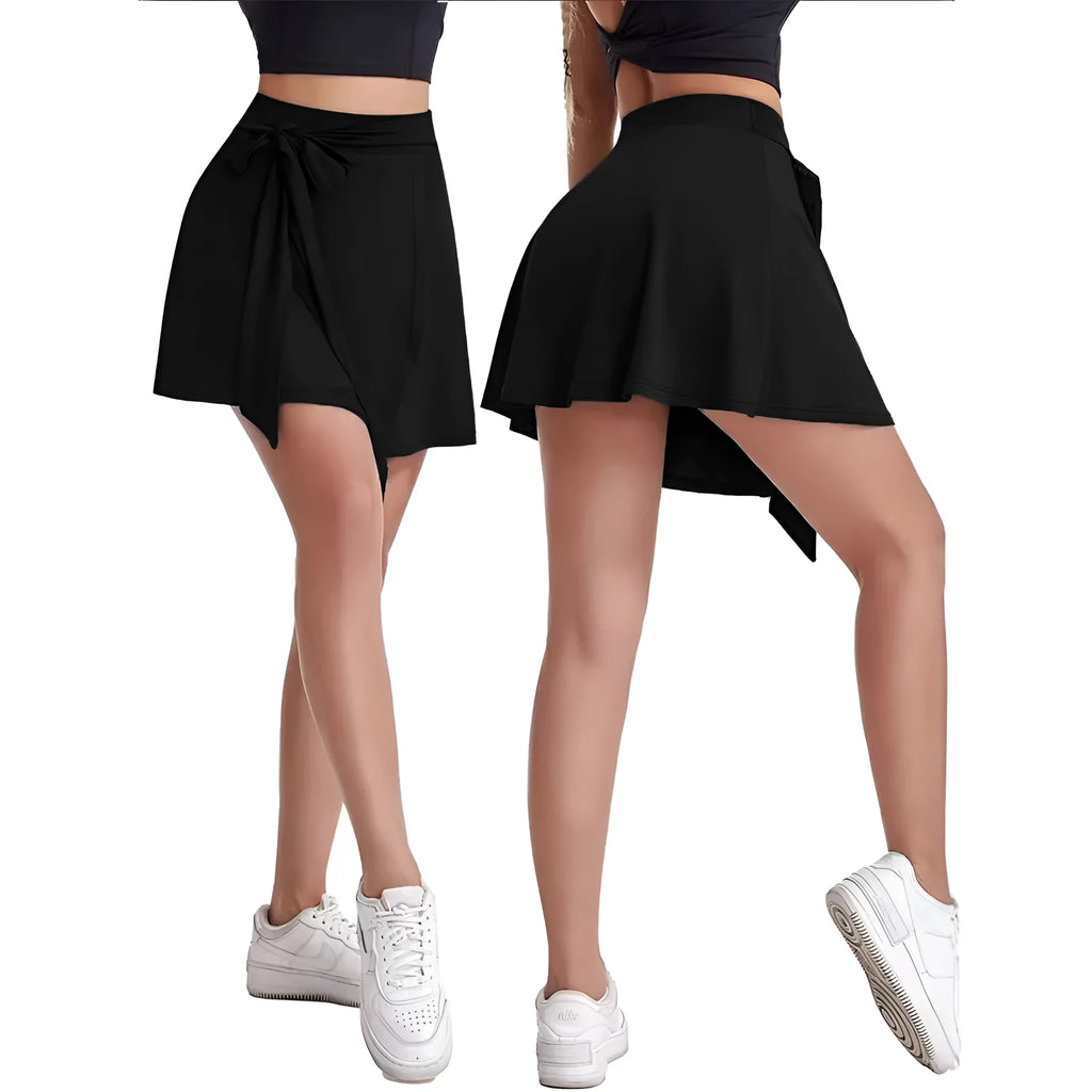 Black thigh-length sports skirt with built-in shorts showing high-waist culotte design and shoulder strap details