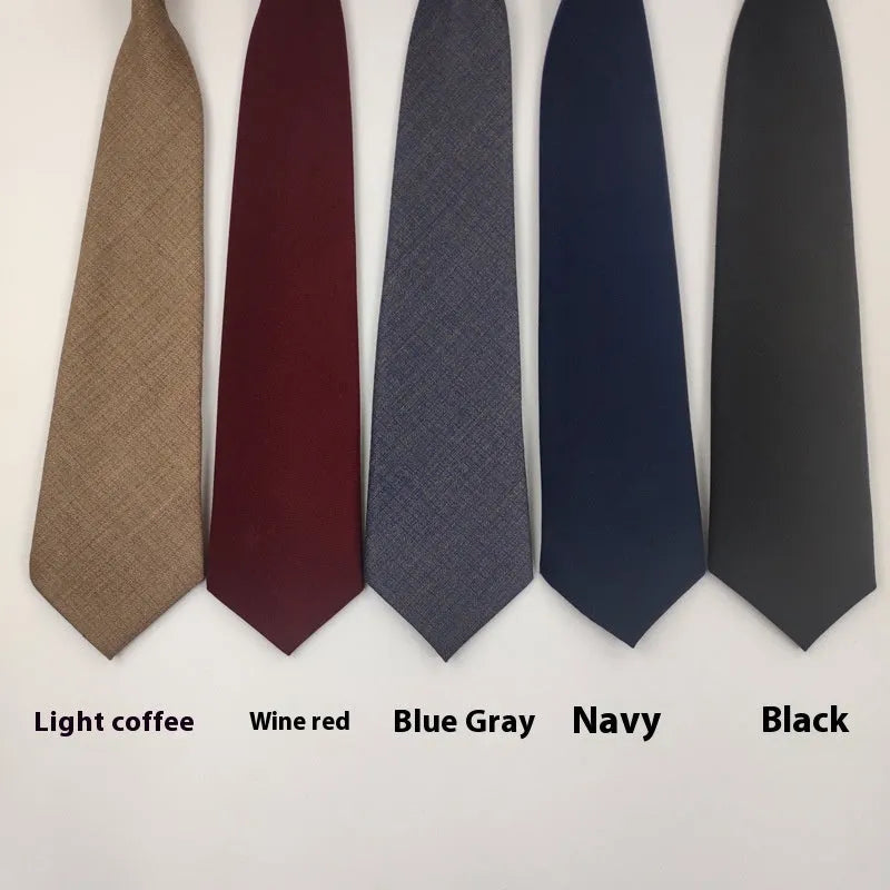 Solid colour men's cotton bow tie in arrow style laid flat, showing navy blue colour option.