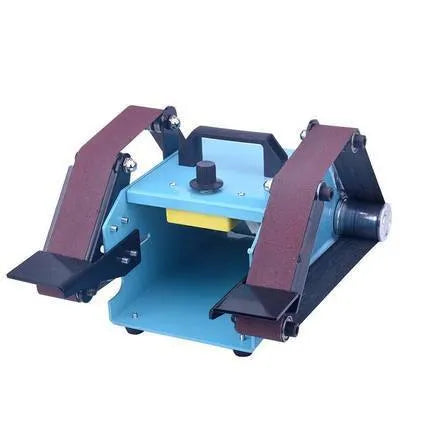 Blue desktop dual-axis belt sander with grinding belt and knife sharpening attachment on workshop bench