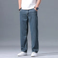 Men's light blue loose straight-leg lyocell jeans with zip fly on a neutral background.