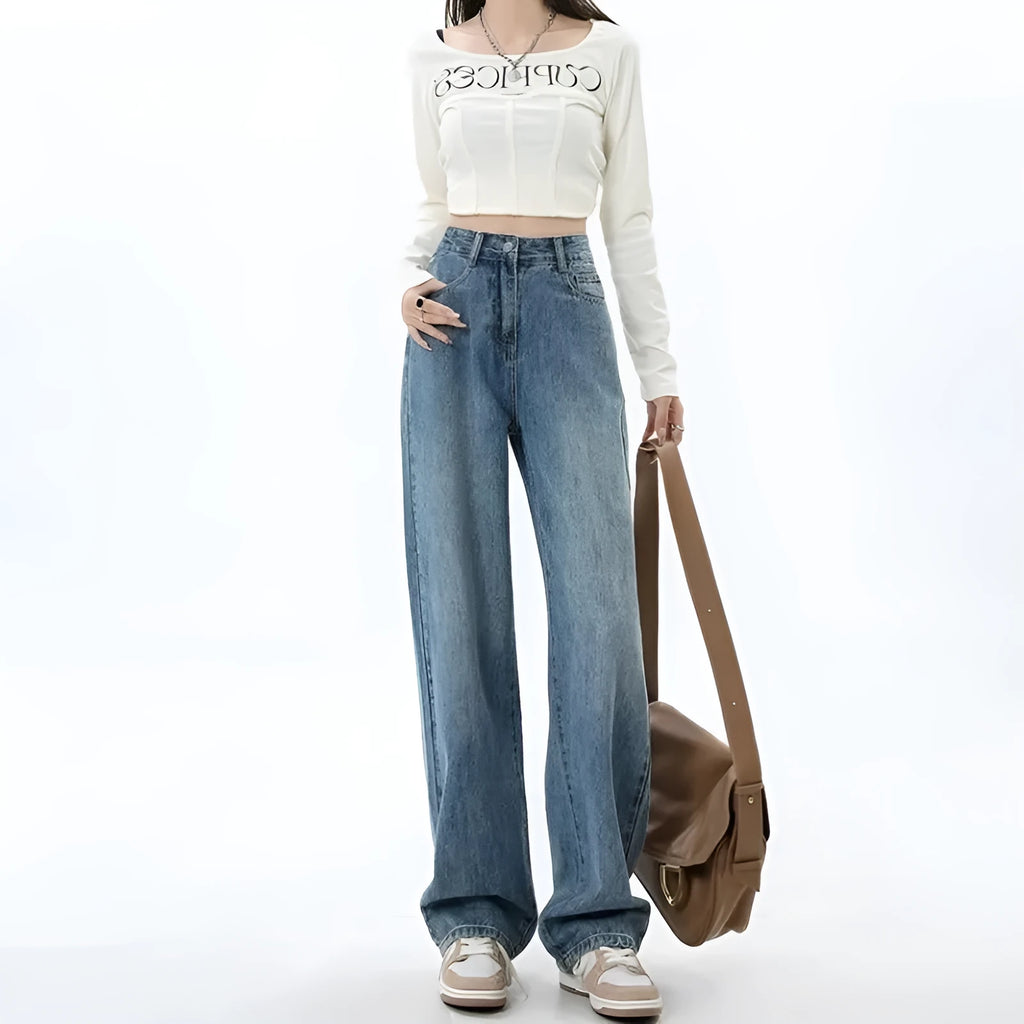 A woman wearing high-waisted retro blue wide-leg jeans made from stretch denim.