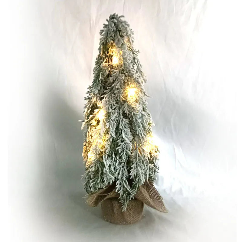 24-inch artificial Christmas tree with snow spray finish and integrated lights on desktop