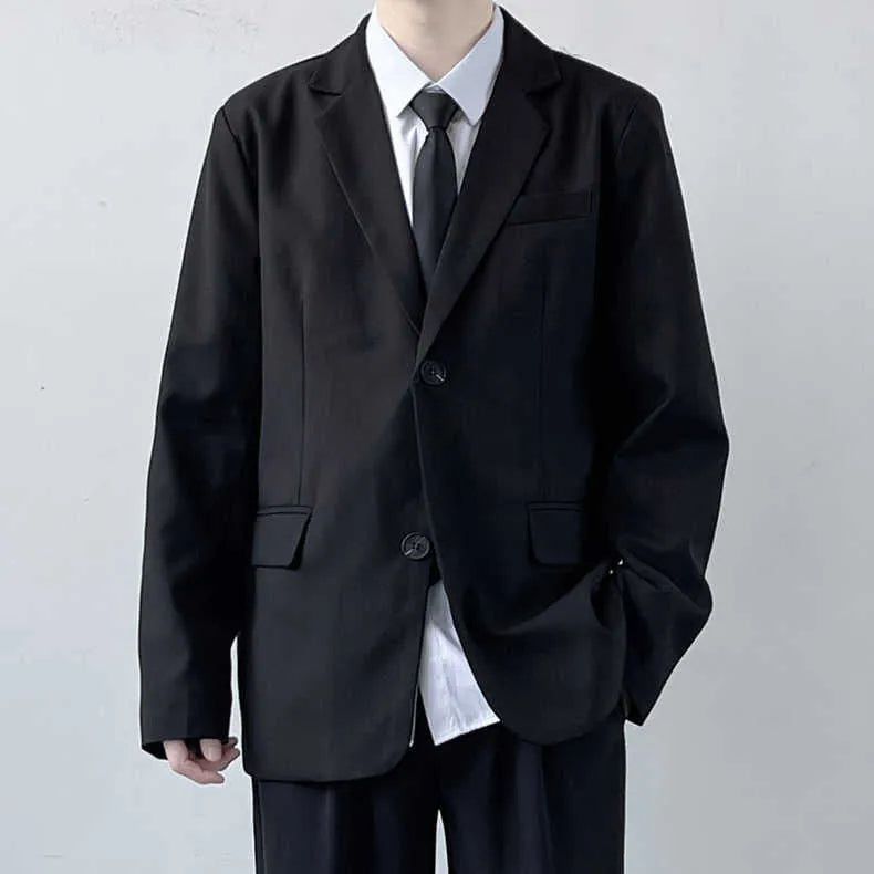 Plus size man wearing a navy college style suit jacket and trousers with a white shirt and blue tie.