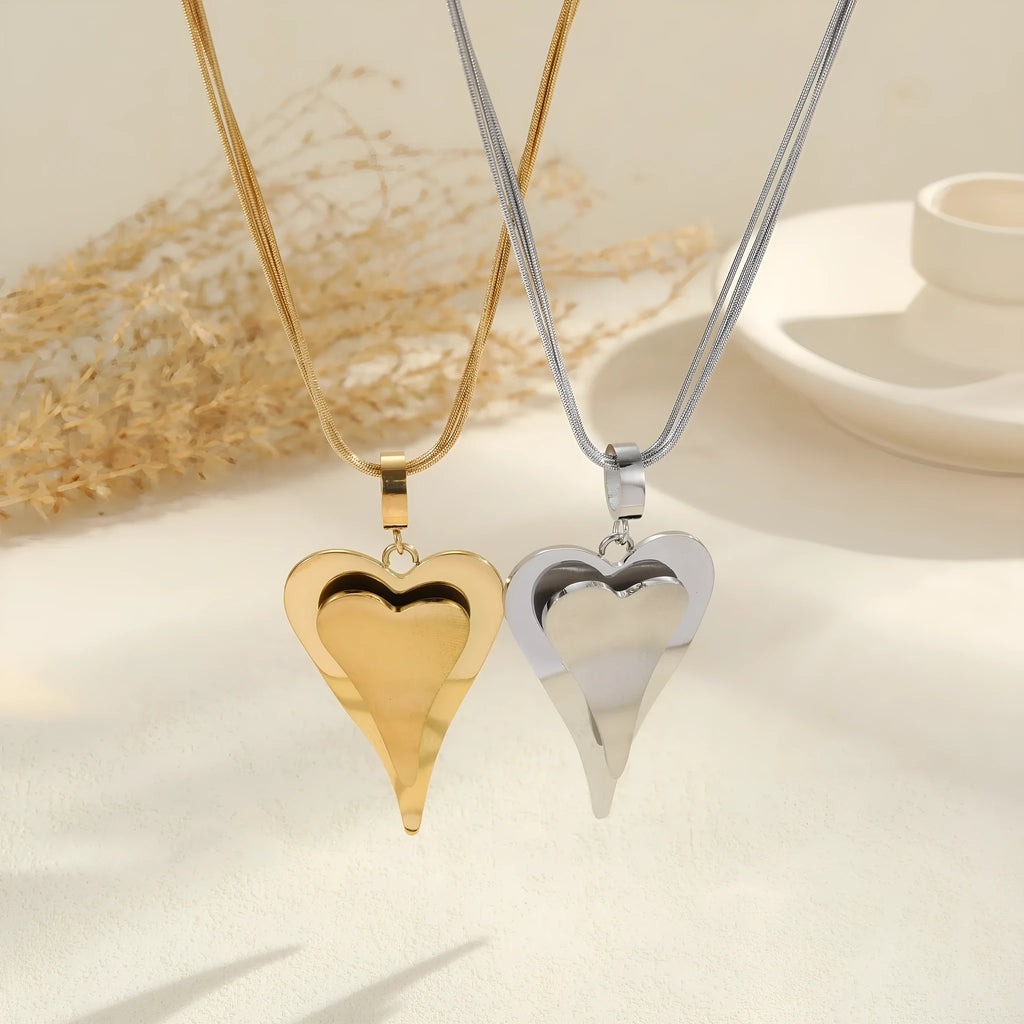 Geometric double-heart pendant on a stainless steel snake bones chain necklace for women, shown in gold and steel finishes.