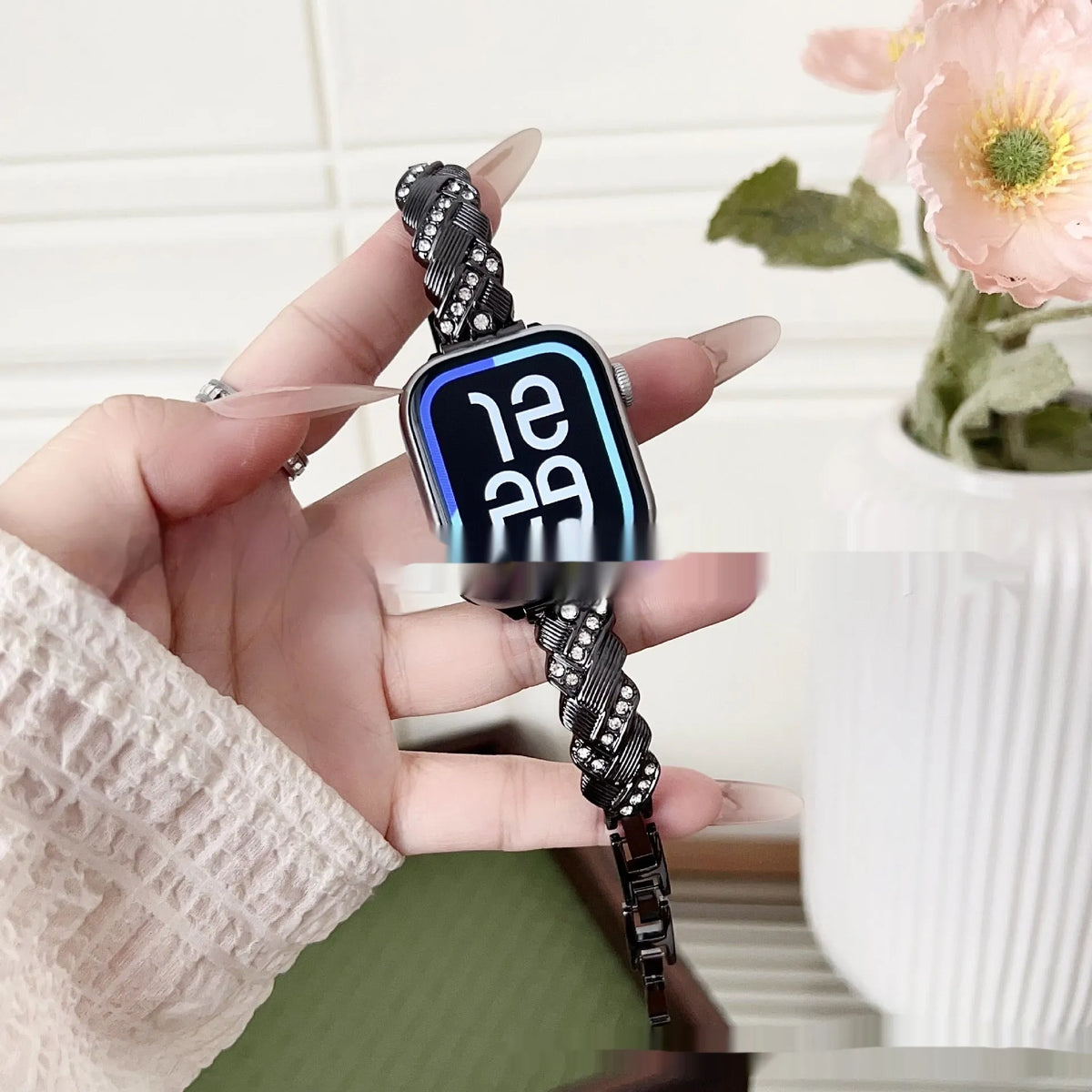 Zinc alloy twist-design Apple Watch band in silver, rose gold, gold, black, and starlight colours on a grey background.