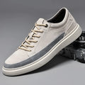 Grey and sand coloured low-top casual skate shoes with pigskin leather upper and rubber sole.