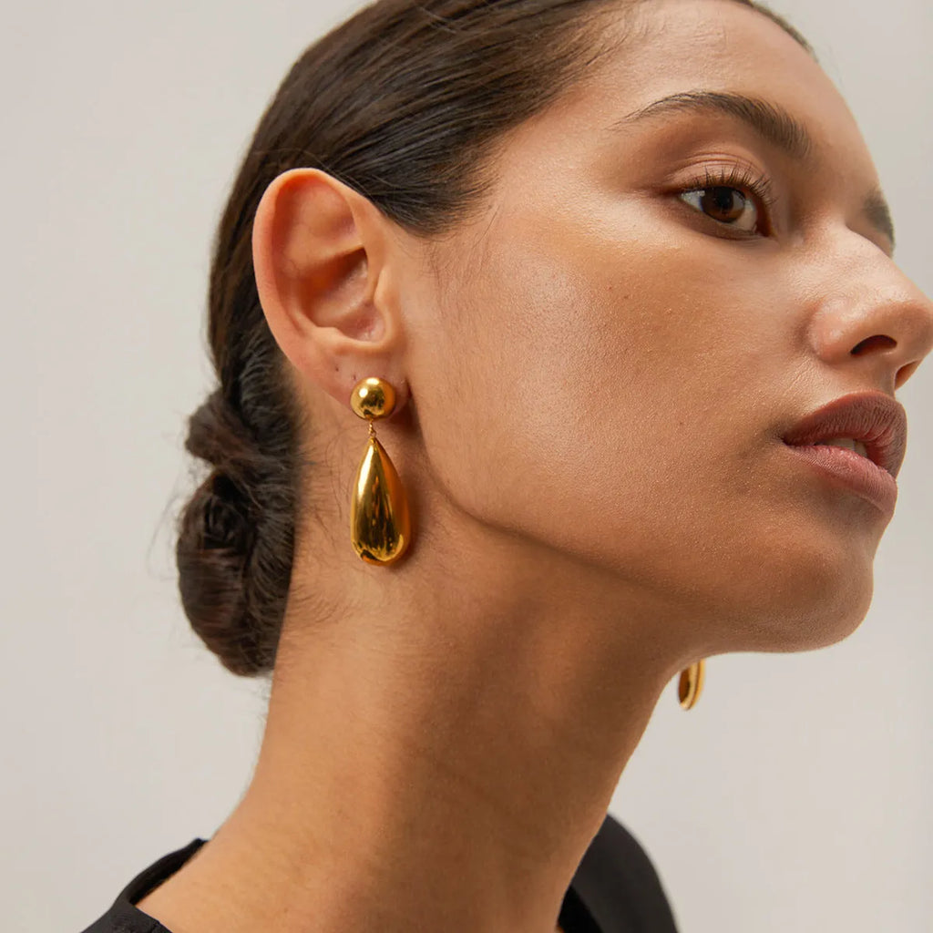 Gold electroplated stainless steel earrings with geometric water drop pendant and hemisphere design