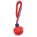 Blue or red natural rubber dog ball with attached rope for tug-of-war and teeth cleaning