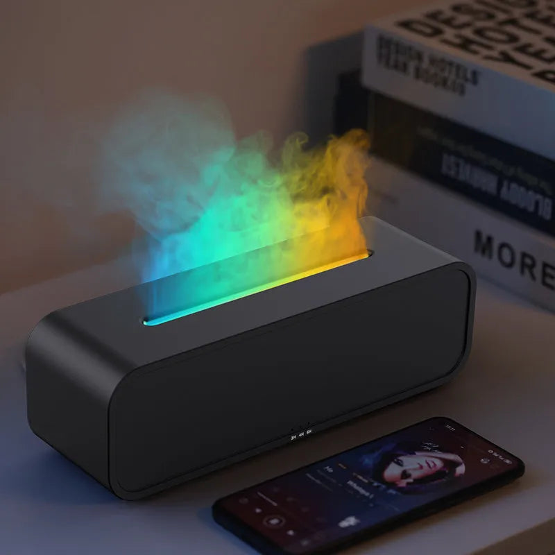 Black and white USB aroma diffuser with remote control and colour-changing lights on a wooden surface