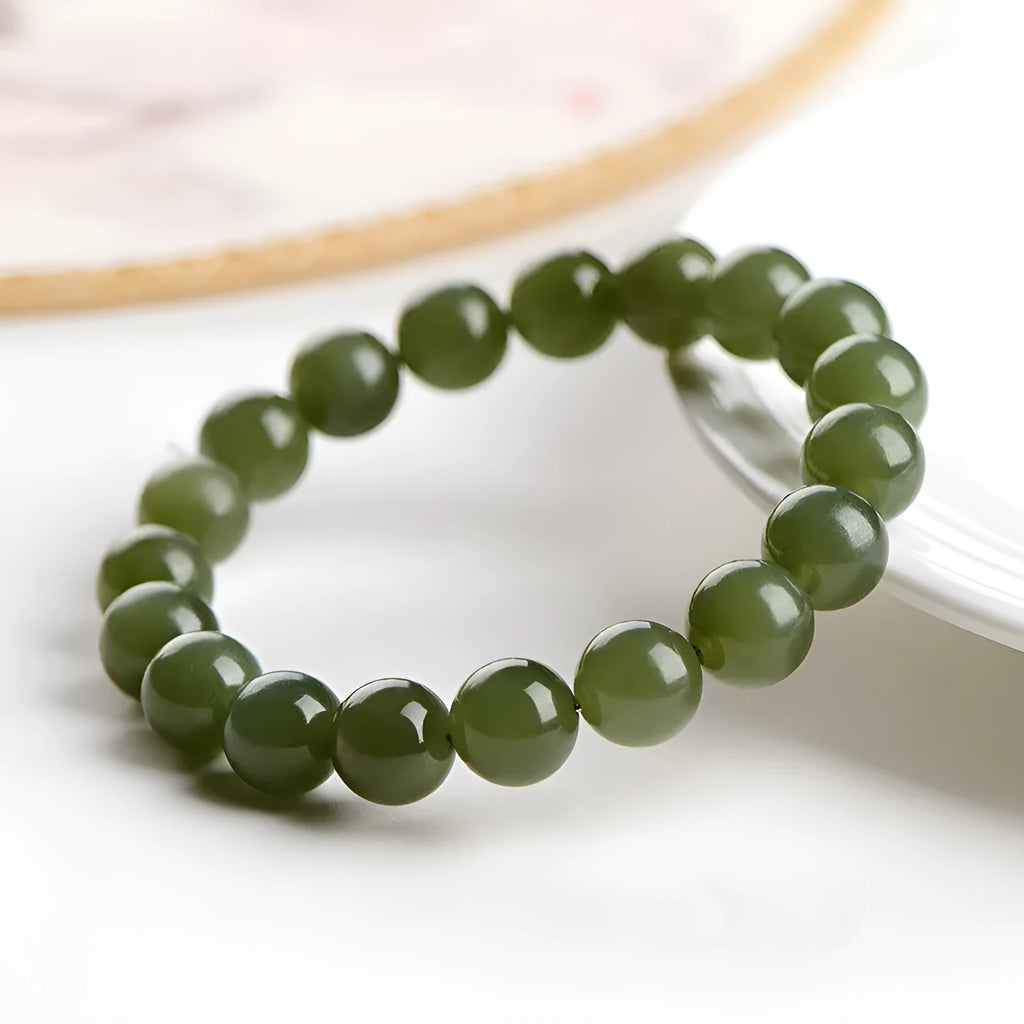 Polished Hetian jade ball bracelet showing ice-like clear beads in deep and light water variations