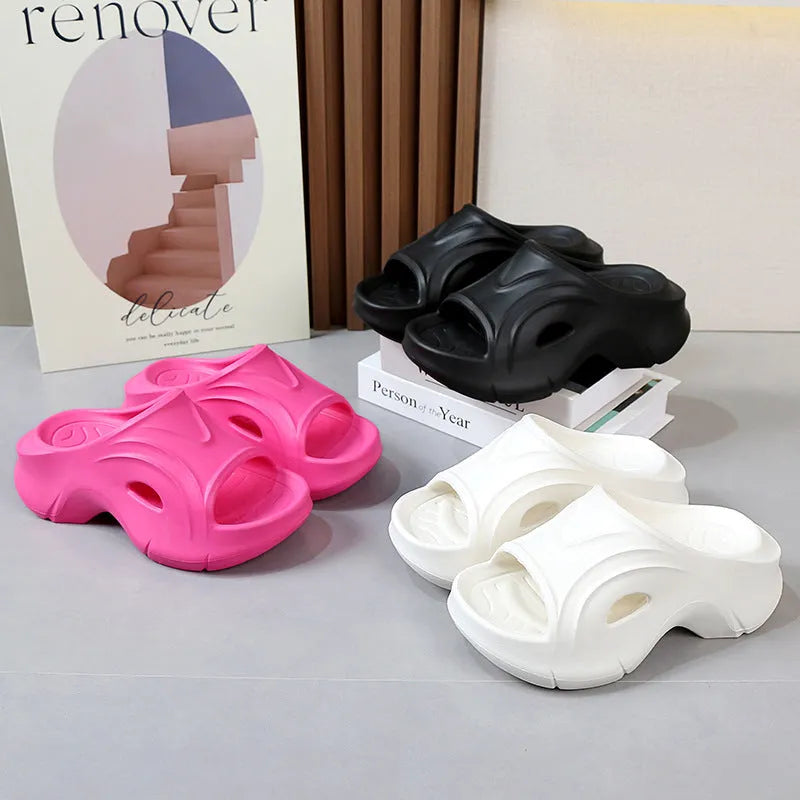 Women's thick-soled EVA beach slippers in rose red colour on a sandy background