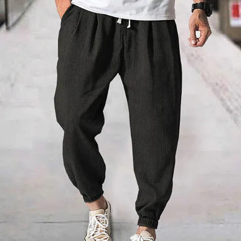 Men's loose cotton casual trousers with elasticated ankle bands in light green