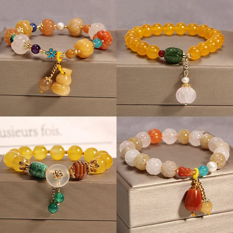 Adjustable khaki bracelet with large yellow agate bead on gold silk cord.