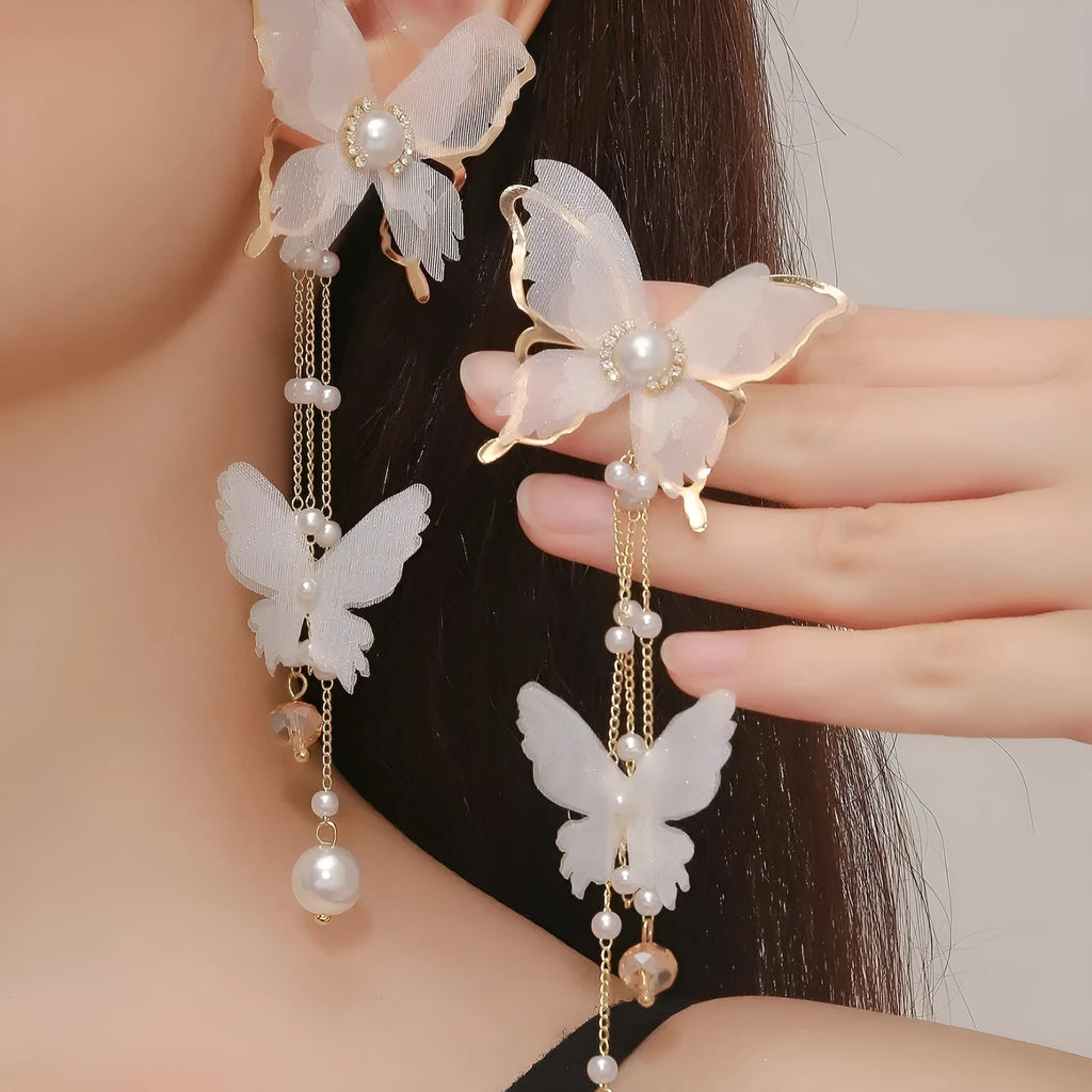 White butterfly earrings with tassel lace design featuring rhinestones and pearls