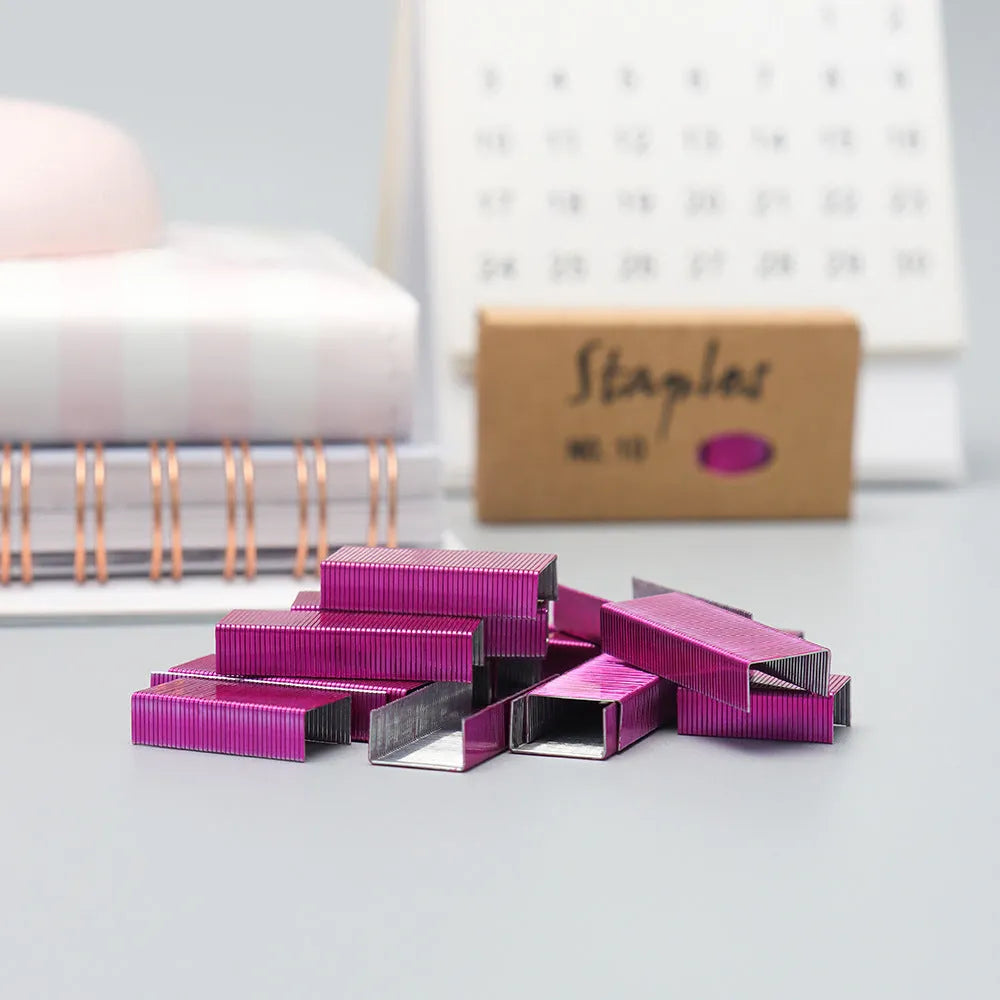 Box of 1000 metal office staples in rose gold, black, purple, and rose red colours