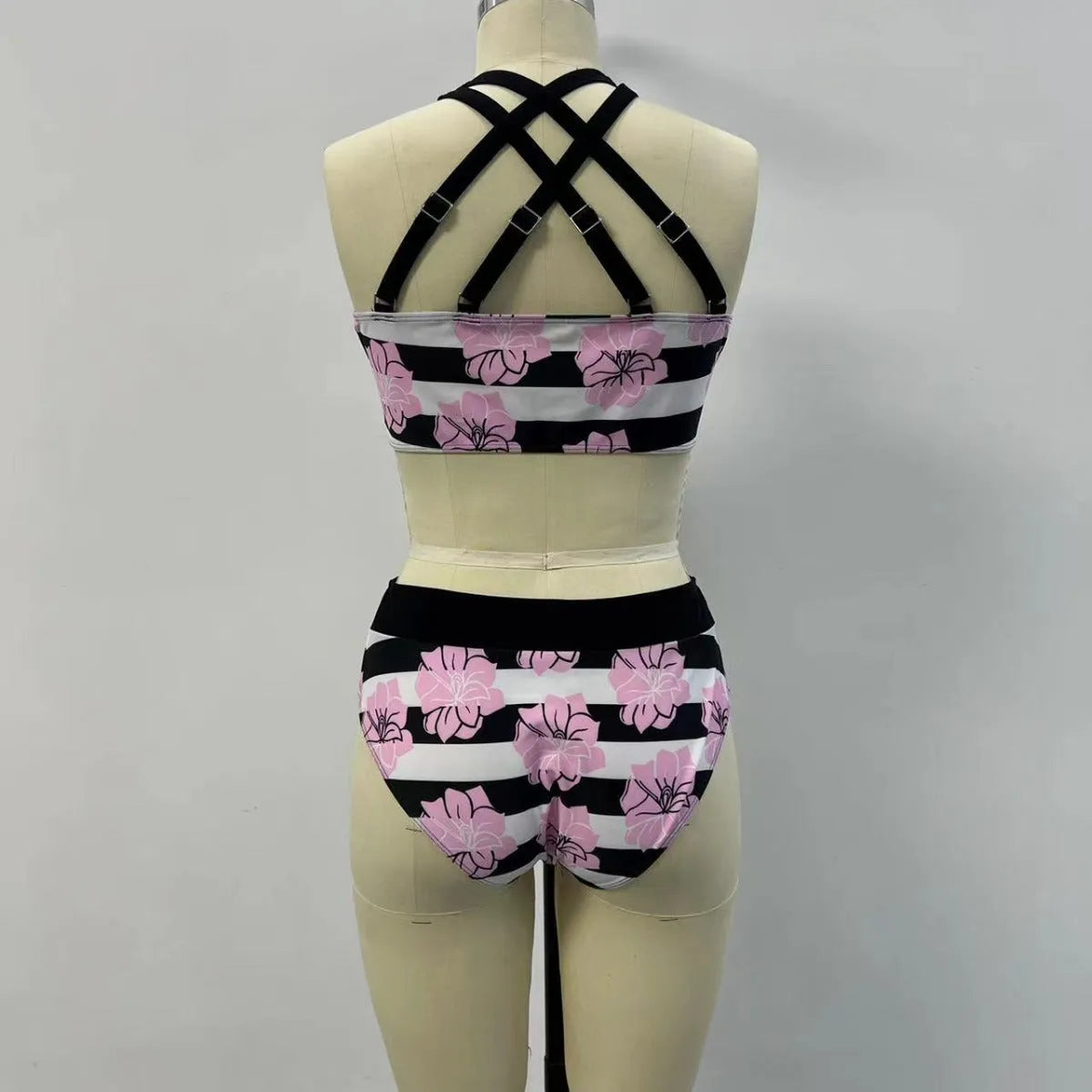 Black women's bikini with printed belly coverage and slimming split leg design.