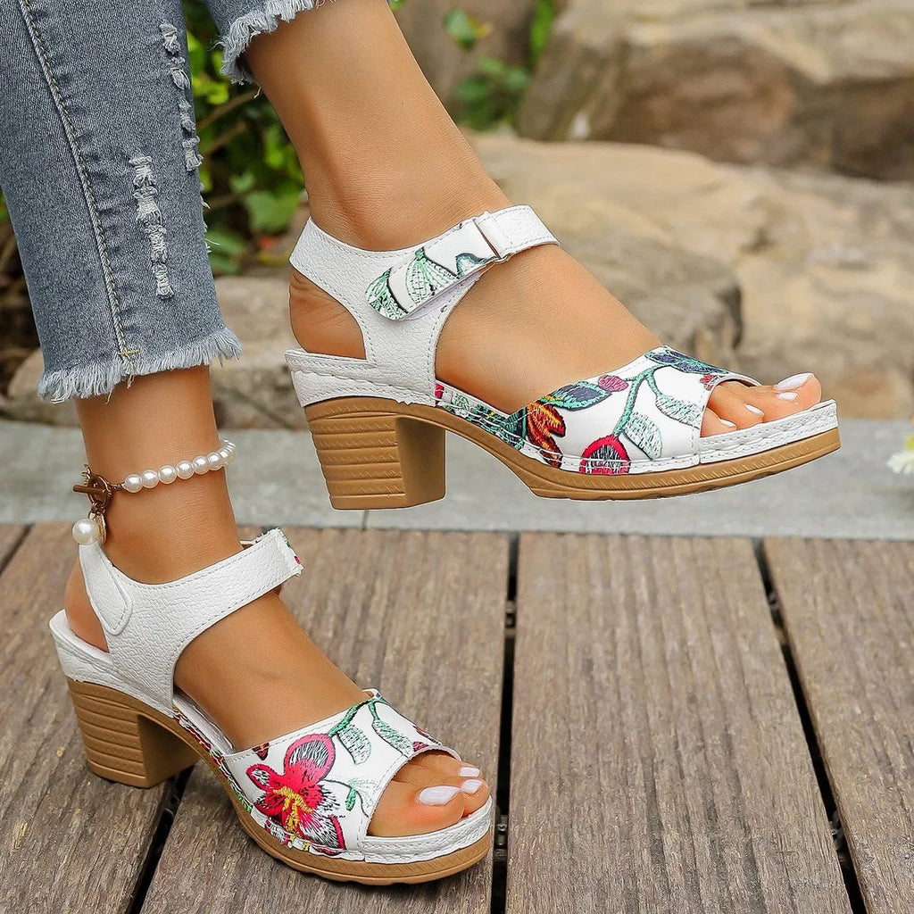 White women's high heel sandals with a velcro buckle strap and rubber sole.