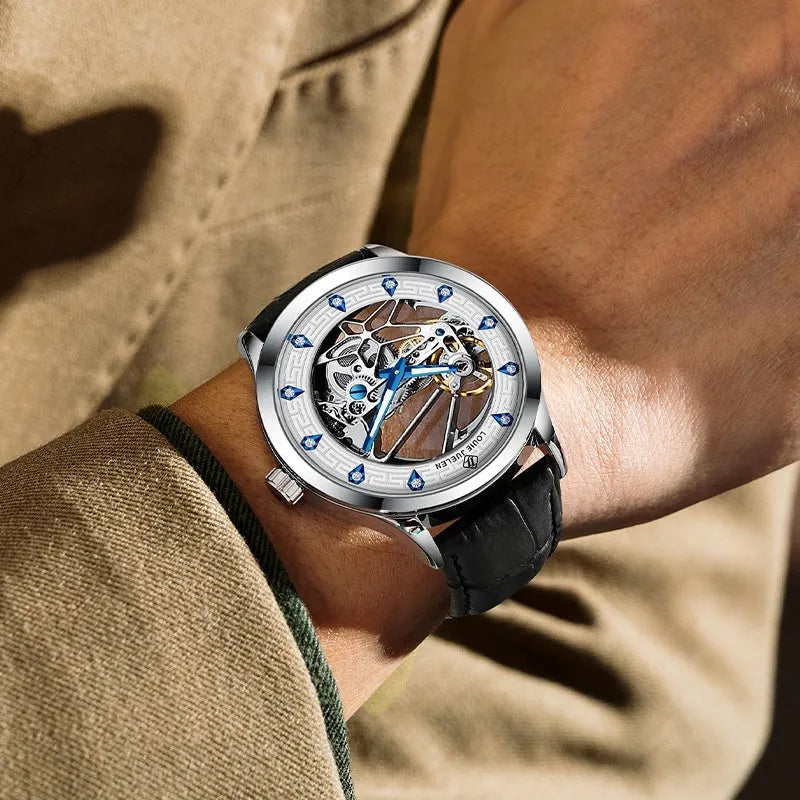 Men's silver mechanical watch with white dial, blue hands, black leather strap, and stainless steel buckle