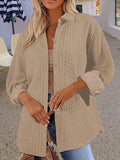 Women's solid colour long sleeve cardigan sweater in black, shown on a hanger.