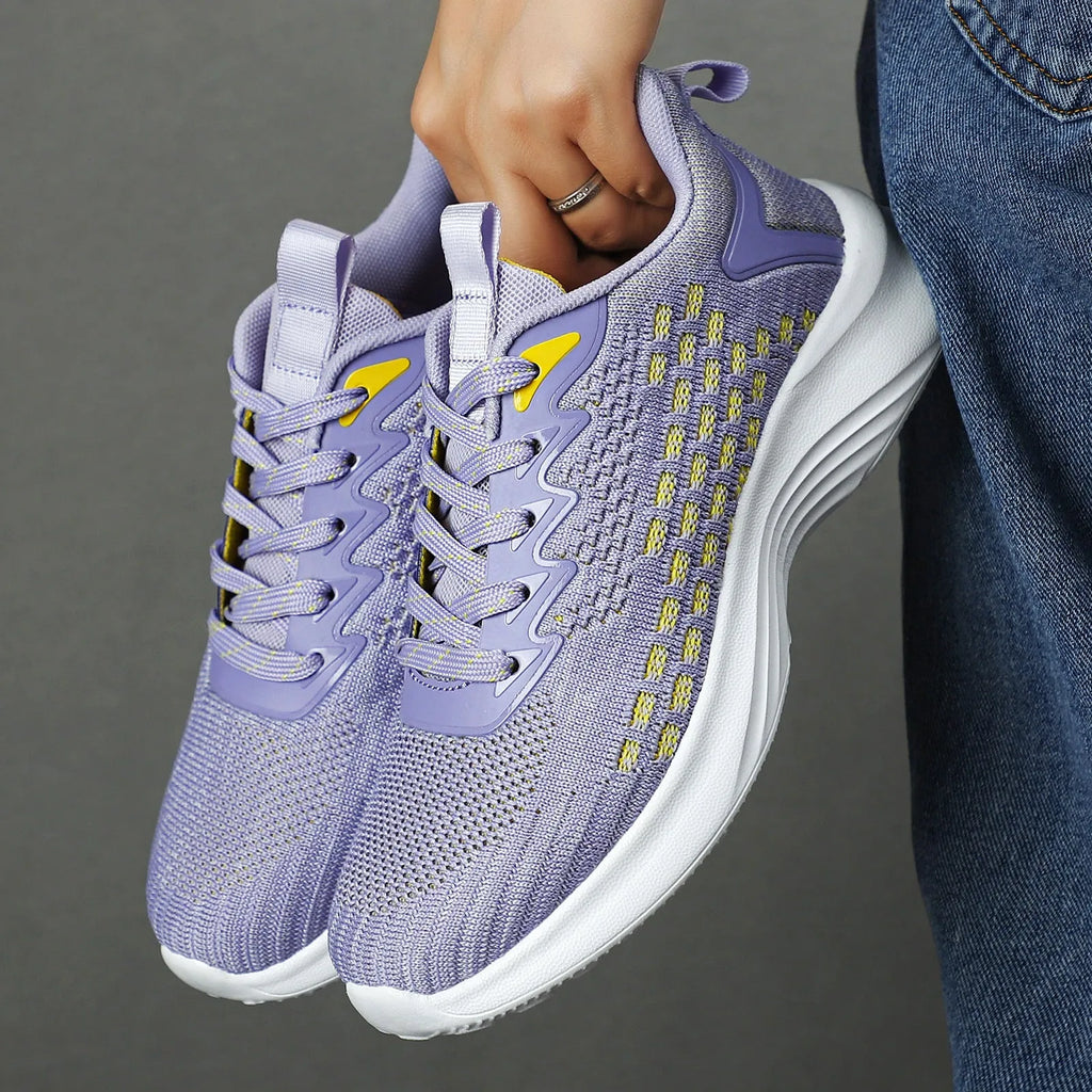 Women's lavender purple and blue Flyknit running shoes with mesh lining and striped pattern.