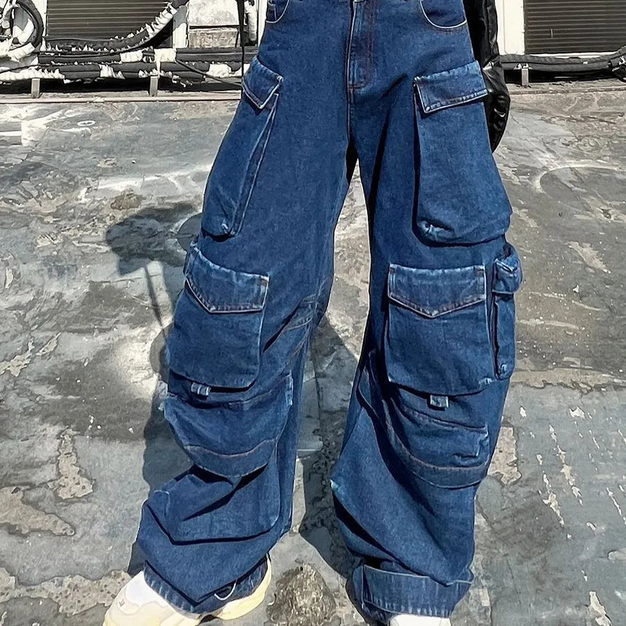 Dark blue distressed women's jeans with a high waist, wide legs, and multiple workwear-style pockets.