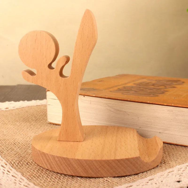 Solid beech wood mobile phone stand with a decorative resin animal ornament and a coin slot.