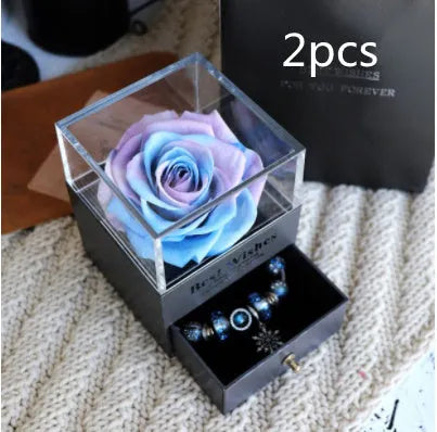 Glass eternal flower jewellery box with preserved roses and carnations inside measuring 8.5cm square