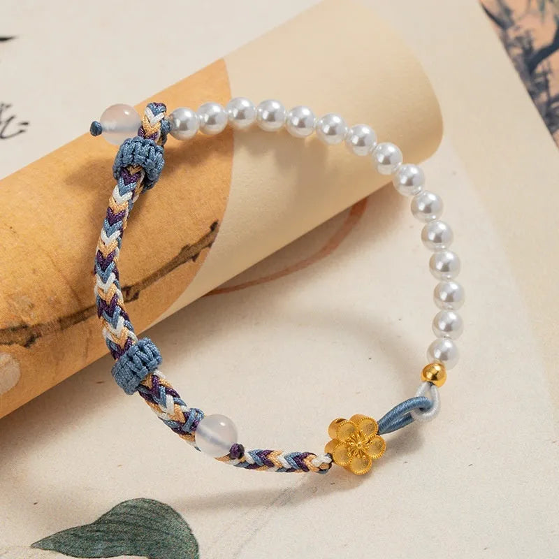 Peach coloured cord carrying strap with electroplated sterling silver chalcedony bead and Chinese flower weaving design