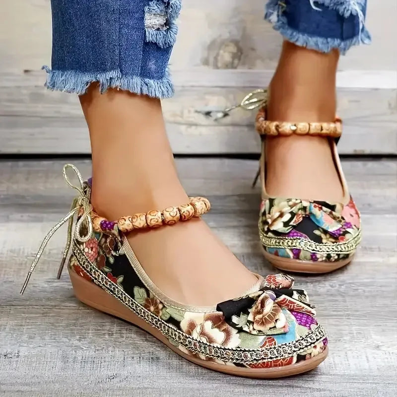 Women's black ethnic style platform sandals with cloth upper and elastic band fastening.