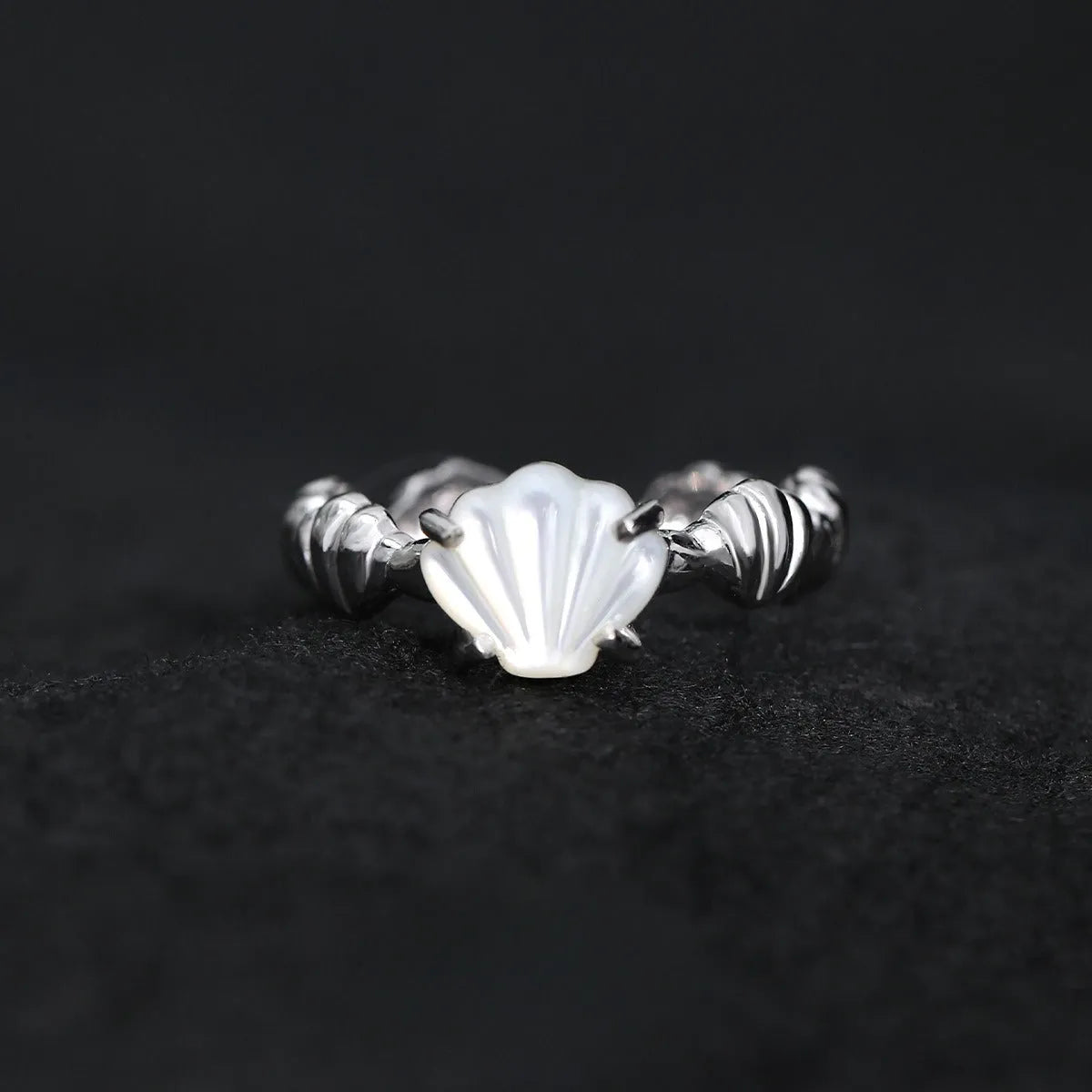 Adjustable silver ring with shell decoration and tiger eye stone on adjustable band
